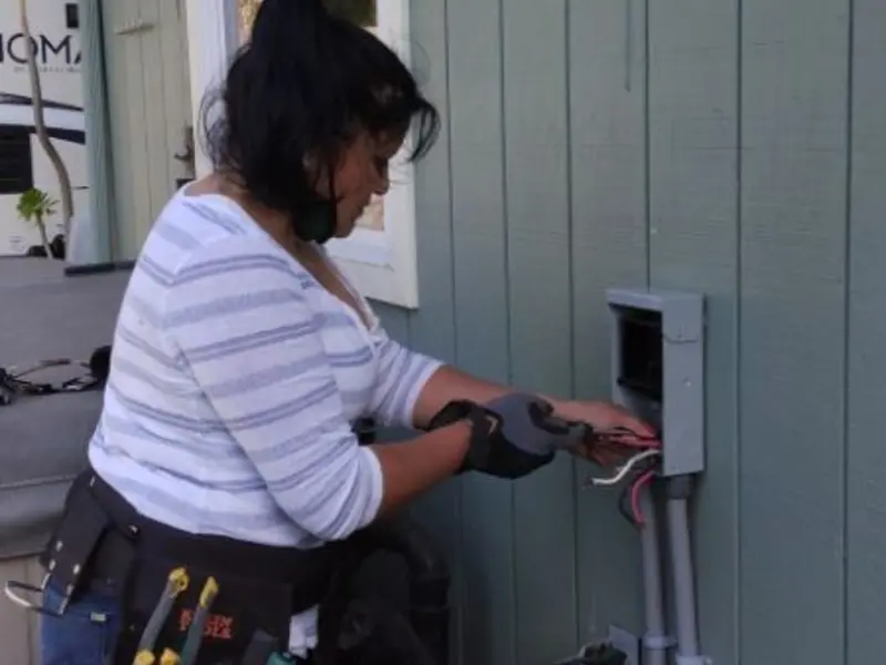 Licensed electrician wiring an exterior subpanel in Cedar Hill