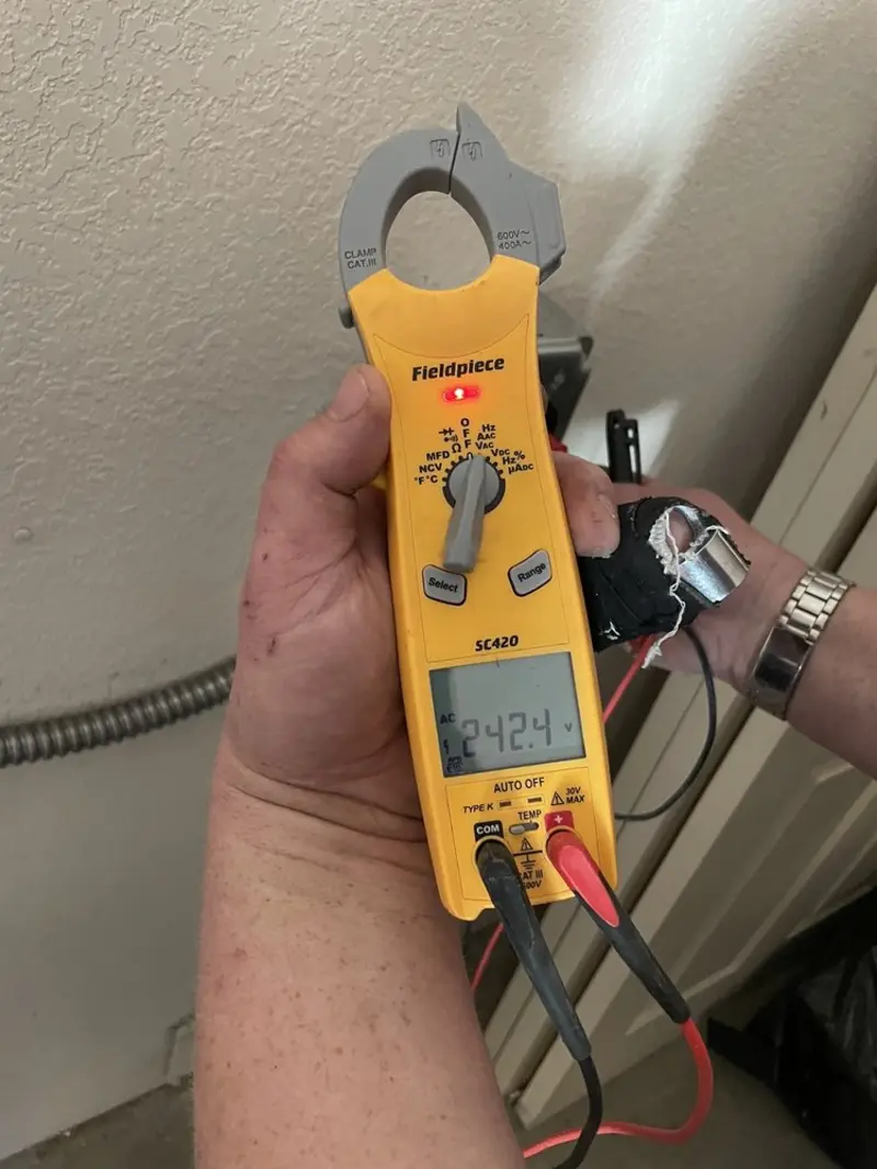 Voltage testing with clamp meter during Outlet Installation in Cedar Hill